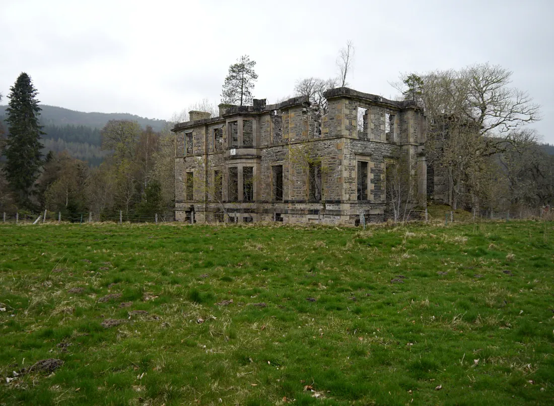 Ruins of Guisachan House in Glen Affric, Scotland, seen across a meadow